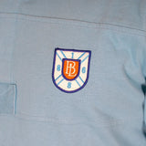 Polo ml jersey peau de pêche bleu turquoise n°9 BACK to LEGEND (zoom sur le badge poitrine)