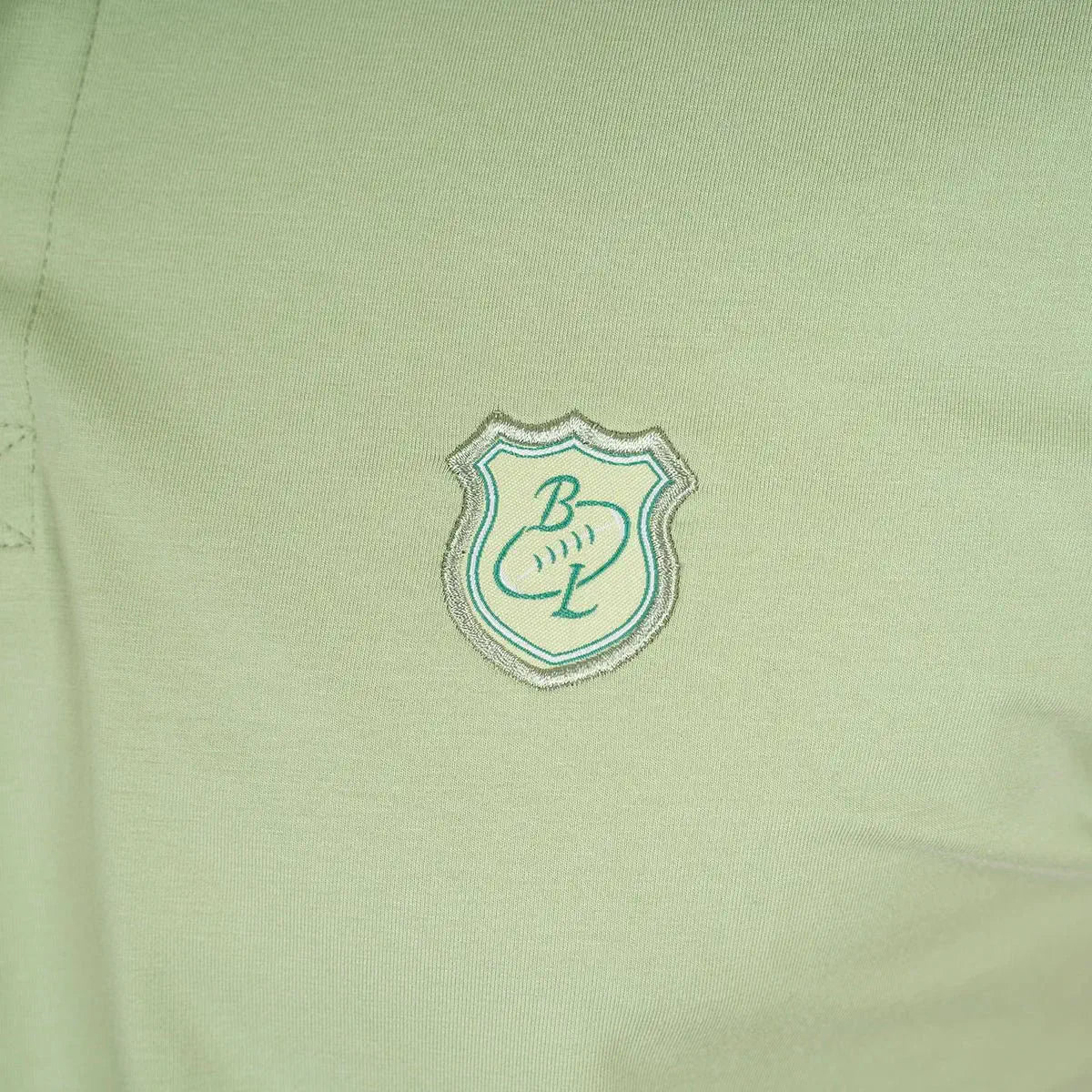 Polo homme vert amande en jersey élasthanne Blacks Legend (zoom sur le logo brodé)